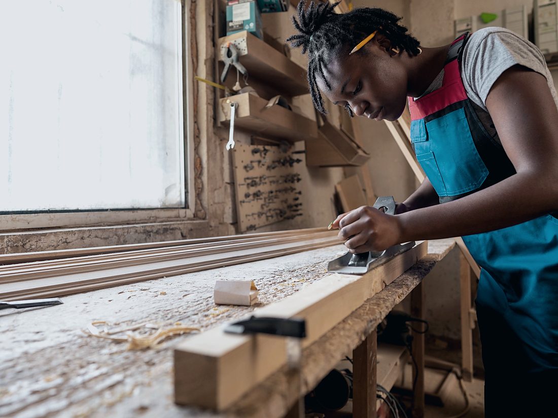 A trainee at work in a carpentry workshop